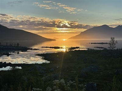 View of the shoreline and mountains at sunset
