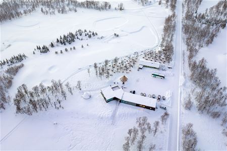 The husky camp at Breivikeidet surrounded by snowy Arctic landscapes and mountains outside Tromsø.