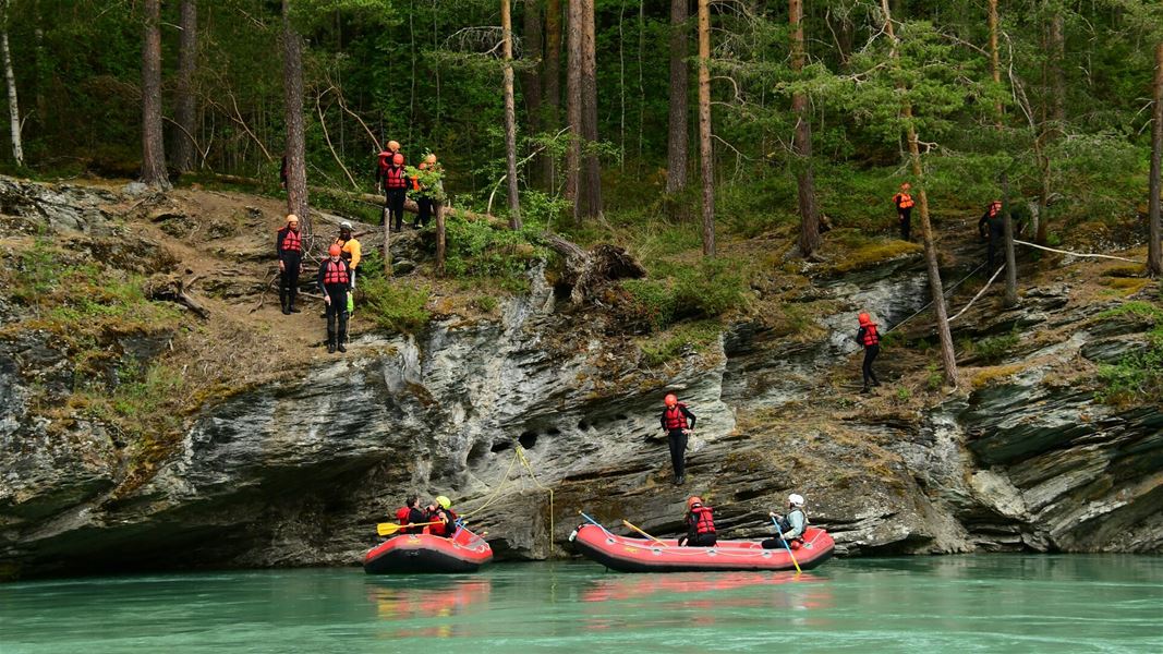 Rafting and river activities in a forested canyon.