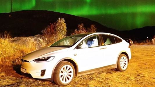 A car under the northern lights