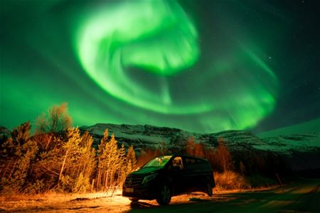 A van under the northern lights
