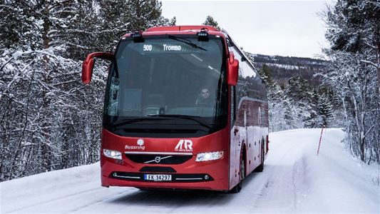 An Arctic Route bus travelling on a snowy road between Tromsø and Narvik.