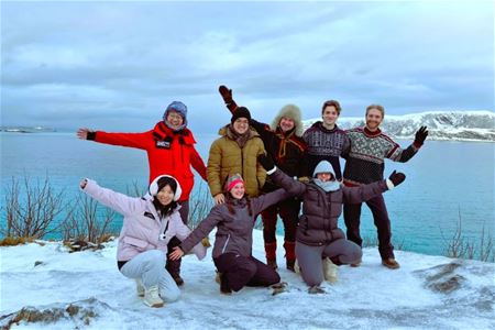 Guests pose for the camera with the fjord in the background.