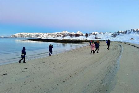 Guests walk along the beach on Sommarøy