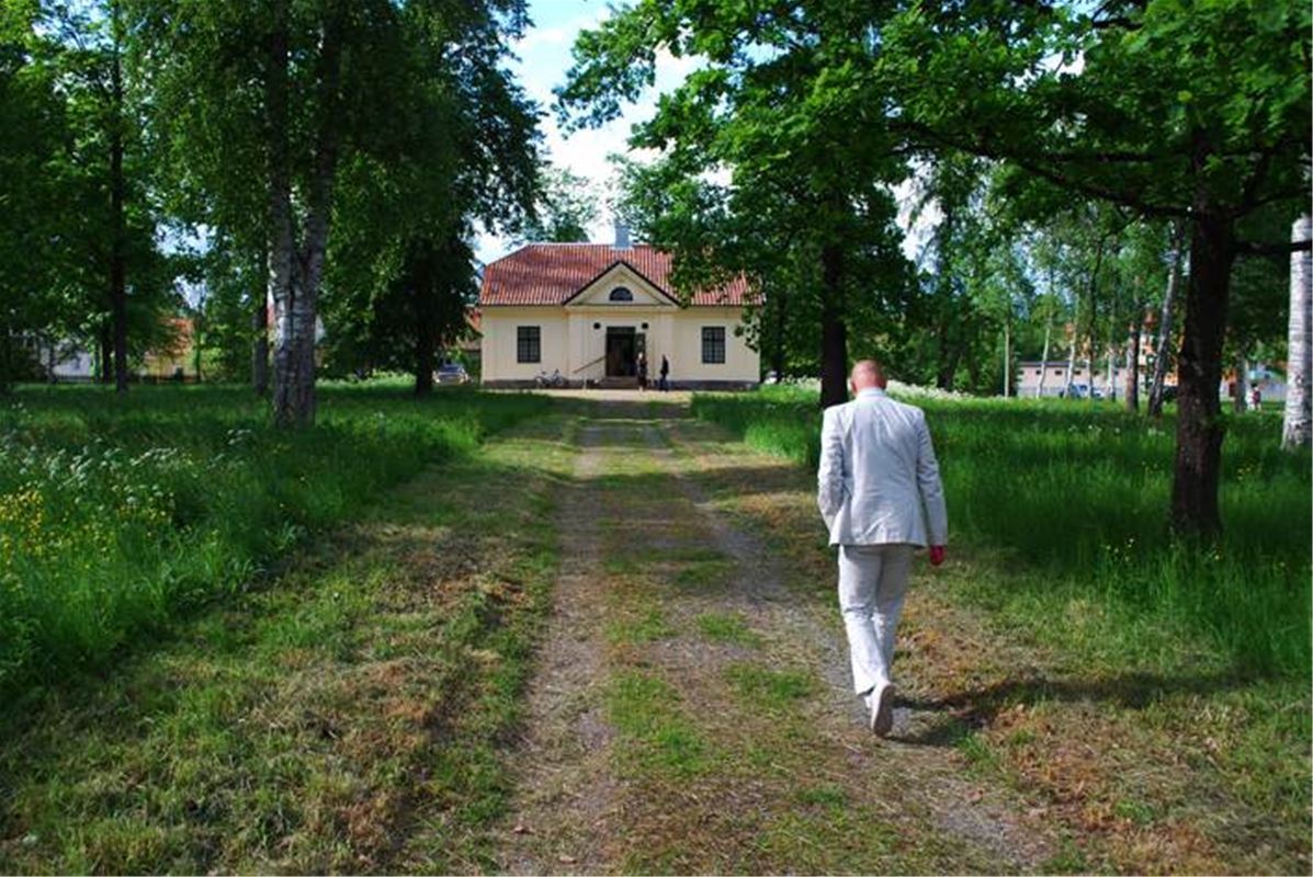 A man walking on the way to the house.