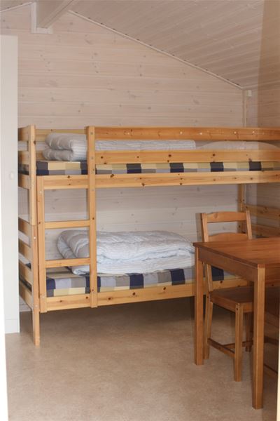 Guest room with bunk bed, table and chairs. 