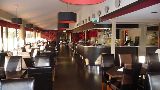 Several tables and chairs inside the restaurant.