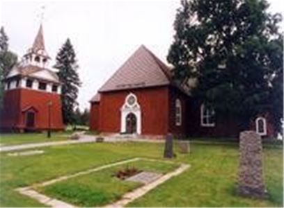 Sundborns church, red wooden building, red klock tower, two head stones.