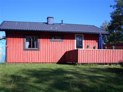 Red cabin with black metal roof.
