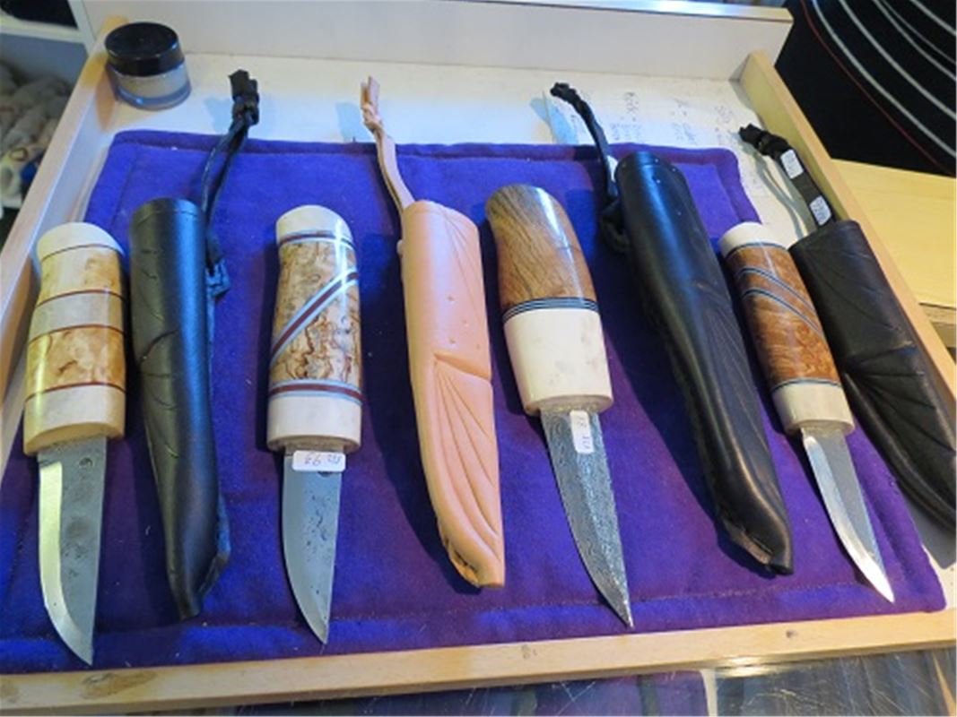 Eight different knifes on a table