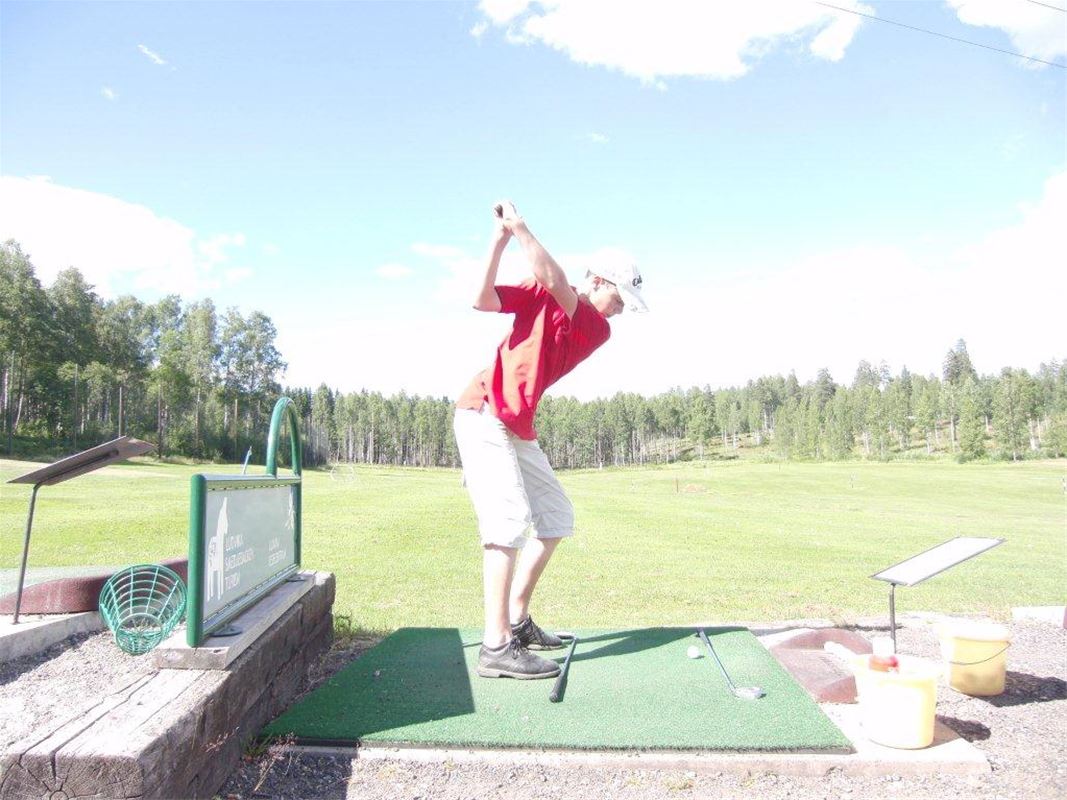 a person playing golf.