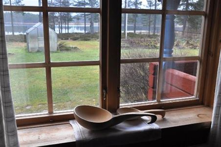 View through the window over the garden and Sästjärn.
