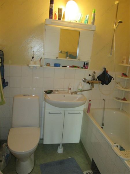 Badrum med toalett, handfat och badkar. 