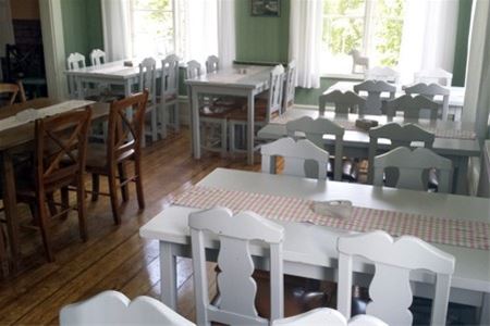 The mansion inside with tables and chairs.