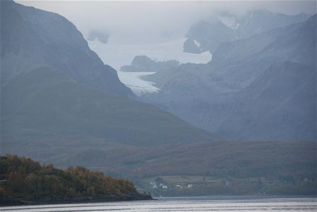 View into cloud covered fjord