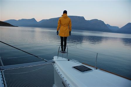 Guest looking out to sea from sailboat