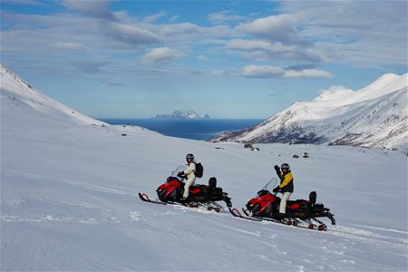 Two guests on snowmobiles