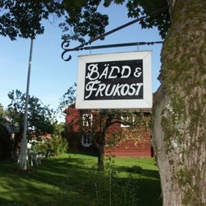 A sign saying bed and breakfast in front of the house.