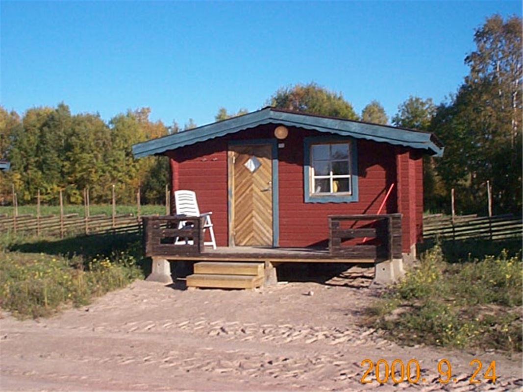 Red painted timber cottage.