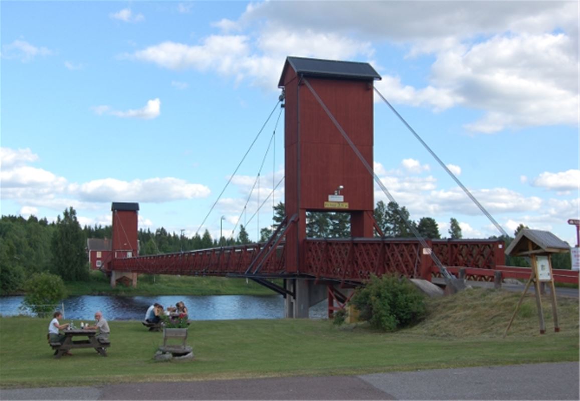 Red wooden suspension bridge.