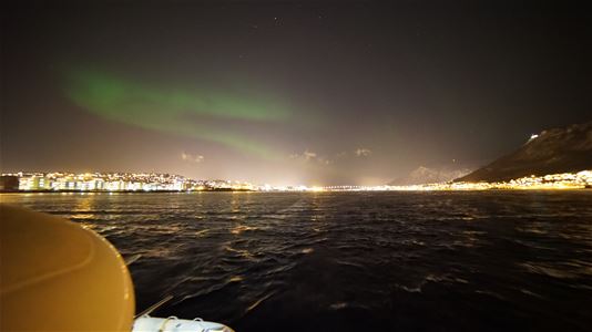 Northern lights far away over the sea