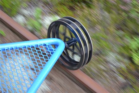 Close up of wheels on a railway trolley.