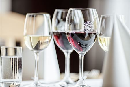 Several wine glasses with red and white wine.