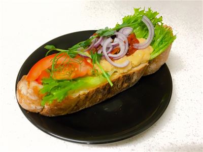 A sandwich on a black plate.
