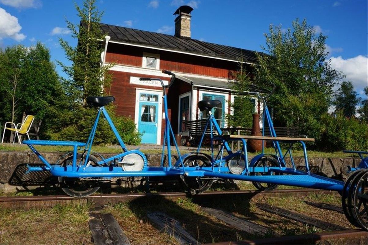 Rail trolley bicycles in front of the house.