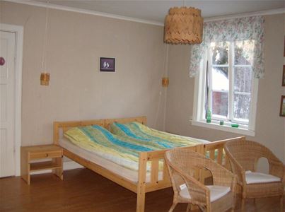 Bedroom with a double bed and two chairs.
