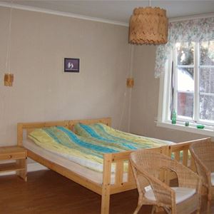 Bedroom with a double bed and two chairs.