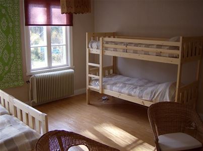 Room with a double bed and bunk beds.