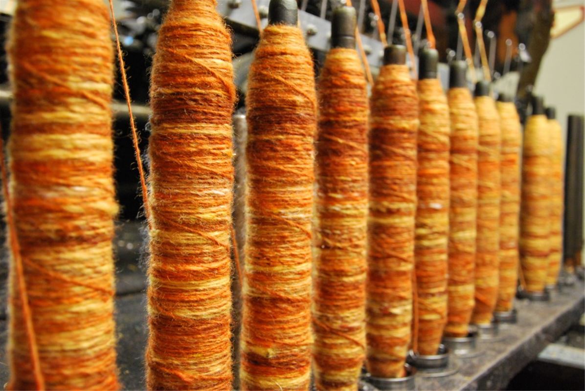 Wool yarn threaded on coils.
