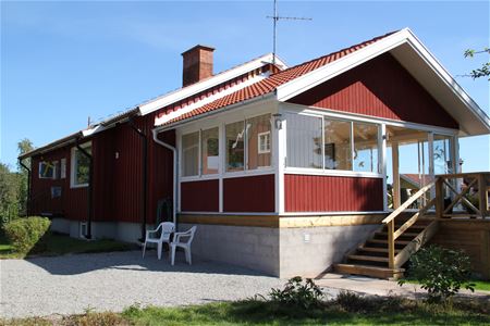 Red house with a veranda.