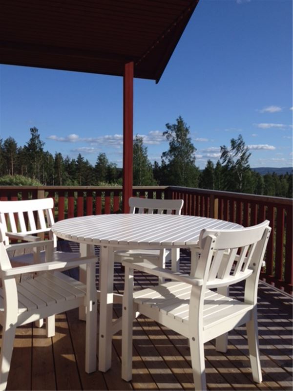 White wooden outdoor furniture on the terrace.