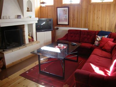 A large sofa in front of a fire place.
