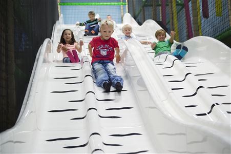 Children ride the slide.