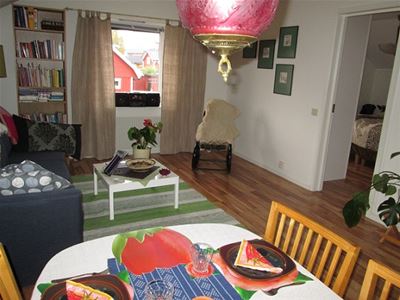 The dining table and a sofa bed in the living room.