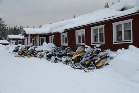 Snowmobiles parked outside.