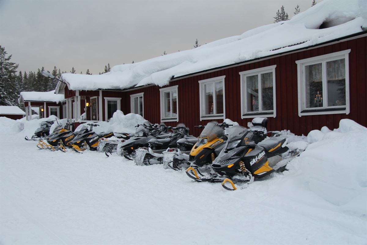 Snowmobiles parked outside.