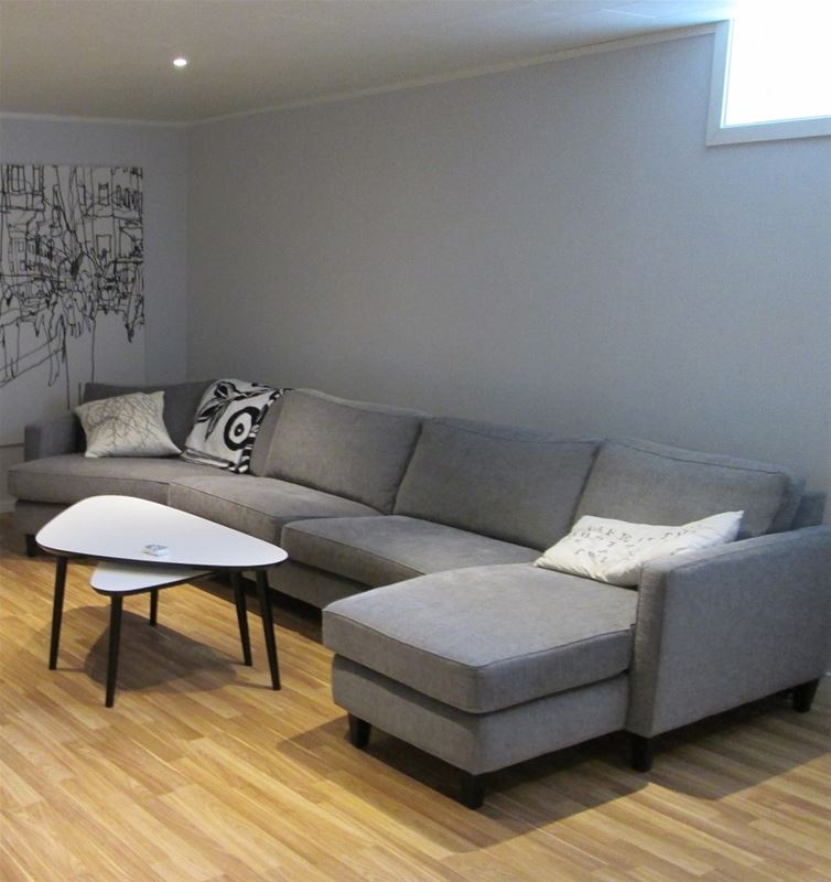 Stor grå soffa med soffbord.