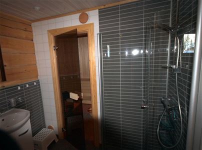 Bathroom with entrance to the sauna.