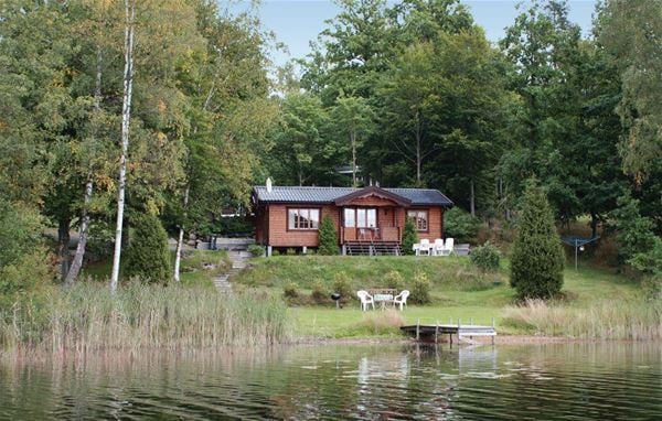Cottage by the lake with a small jetty 