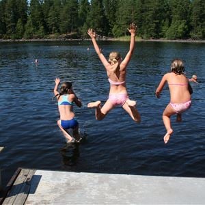 Children jumping from a jetty