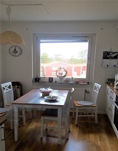 The kitchen with a dining table and four chairs.