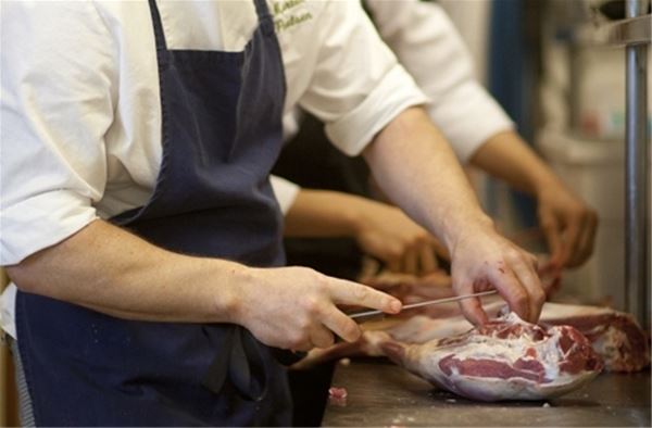 Chefs cutting meat.  