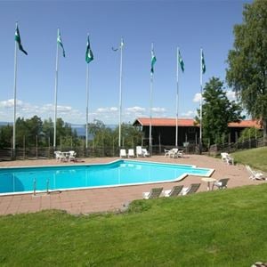 Outdoor pool and several flagpoles in a row. 