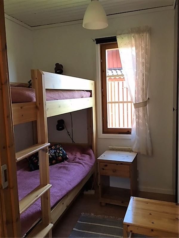 Bunkbed with purple bedcover. 