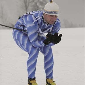 Male skier in the ski tracks.