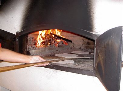 Baking oven with fire and breadbaking.